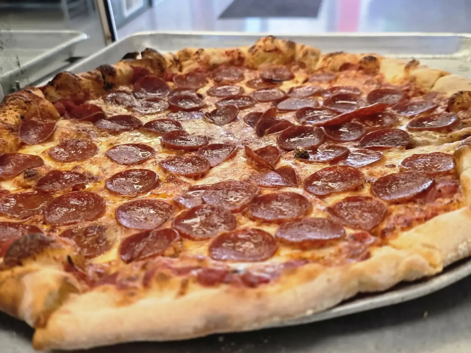 An 18-inch pepperoni pie on a sheet pan